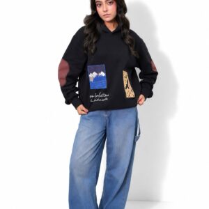 Model wearing the Manzil black patch hoodie with wide-leg jeans, full length