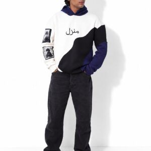 Model in the Manzil navy, white and black colour-block hoodie, standing full length