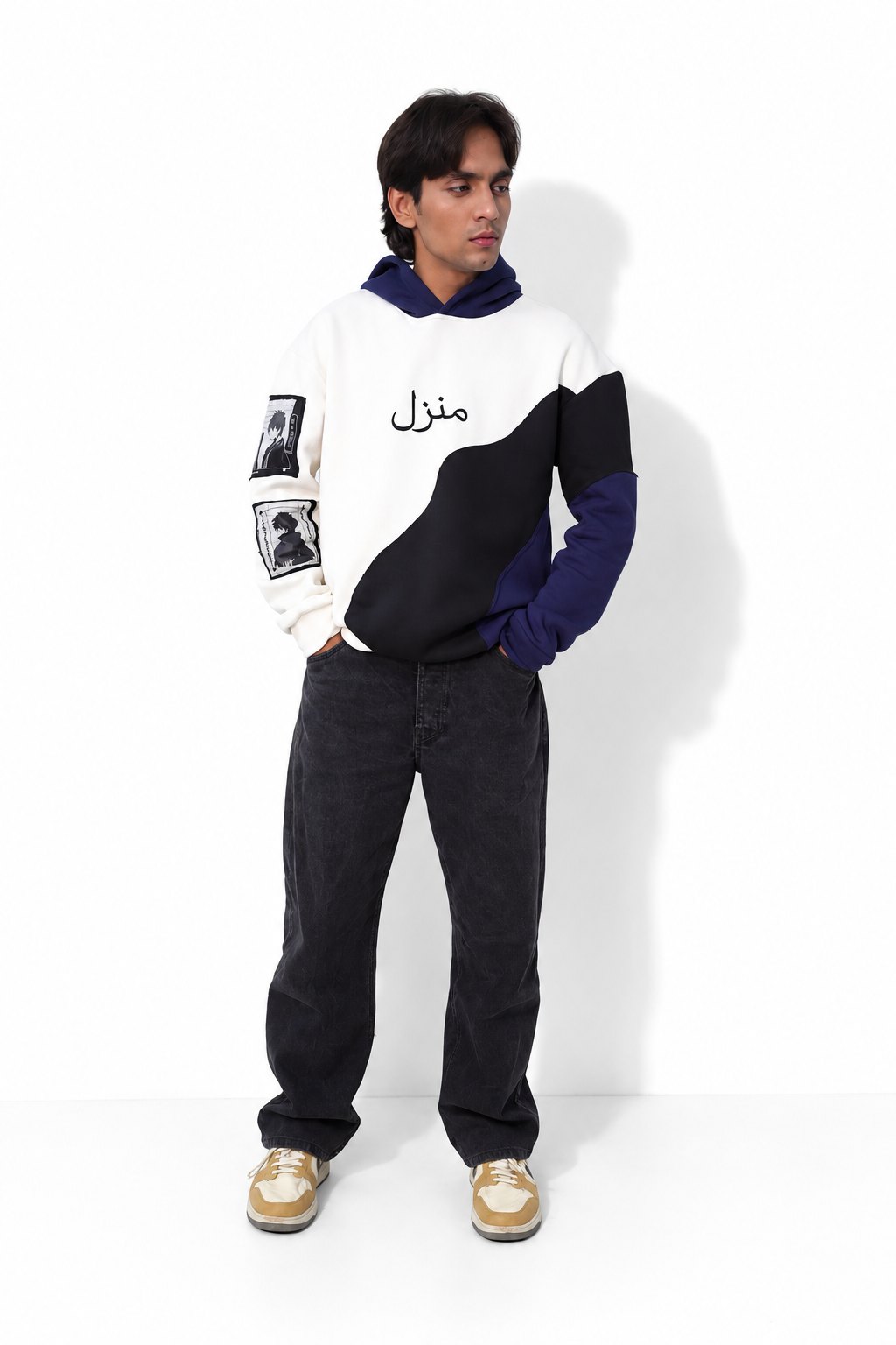 Model in the Manzil navy, white and black colour-block hoodie, standing full length