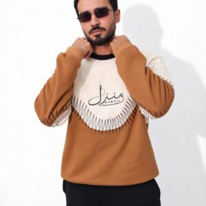 Model in the Manzil tan and cream colour-block sweatshirt with Urdu Manzil print, front view