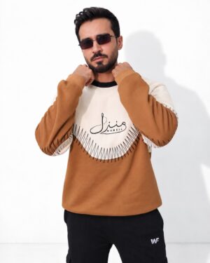 Model in the Manzil tan and cream colour-block sweatshirt with Urdu Manzil print, front view